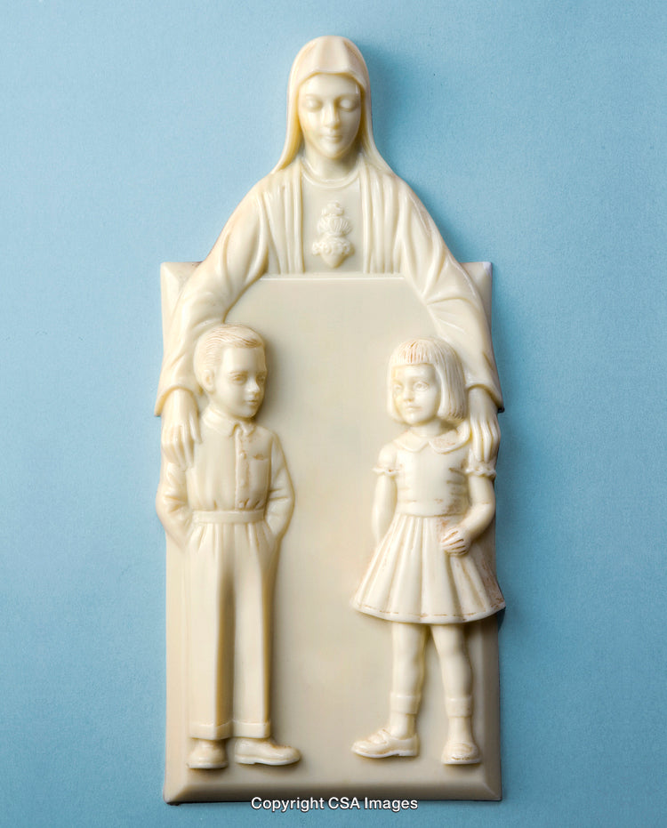 Religious Sculpture Depicting Woman and Children on Light Blue Background