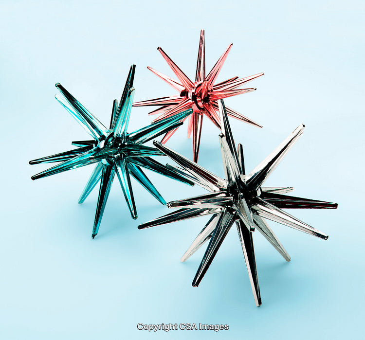 Colorful Geometric Star-Shaped Plastic Toys Against a Light Blue Background