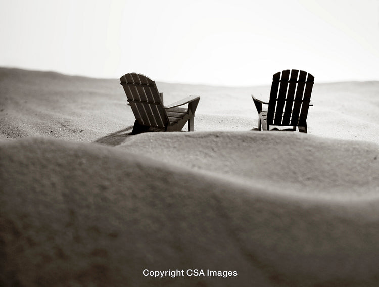 Two Miniature Adirondack Chairs amidst Sand-Like Surface in Black and White