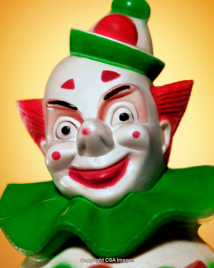 Colorful Clown Figurine Close-Up on Vibrant Yellow Background