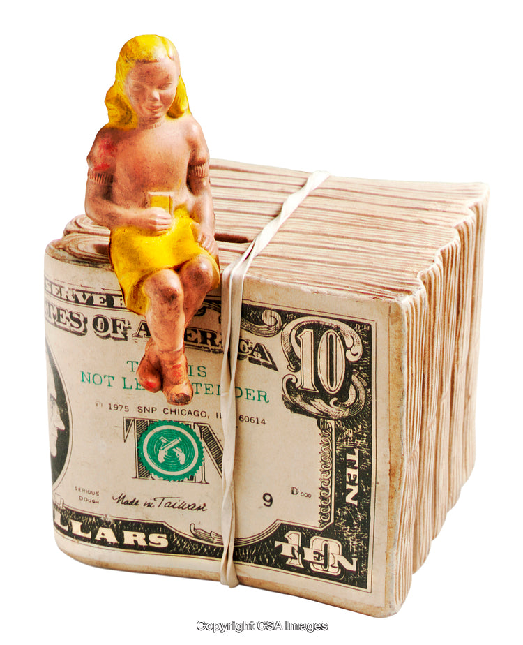 Plastic Figure Sitting on a Stack of Bound Ten Dollar Bills