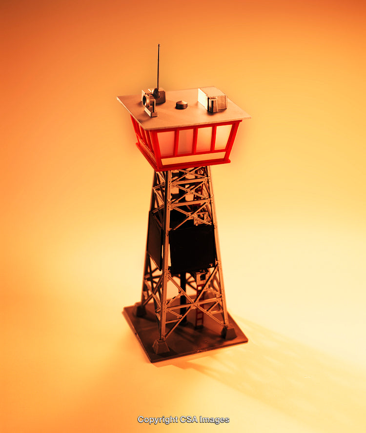 Miniature Observation Tower Against Radiant Warm Orange Background