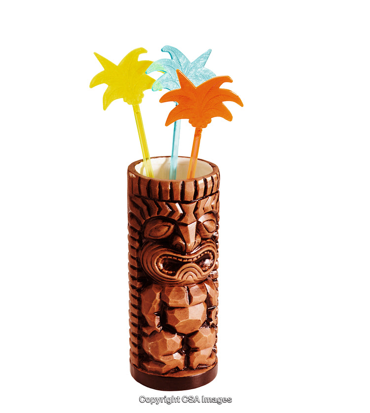 Tiki Mug with Decorative Palm Tree Cocktail Stirrers Against White Background