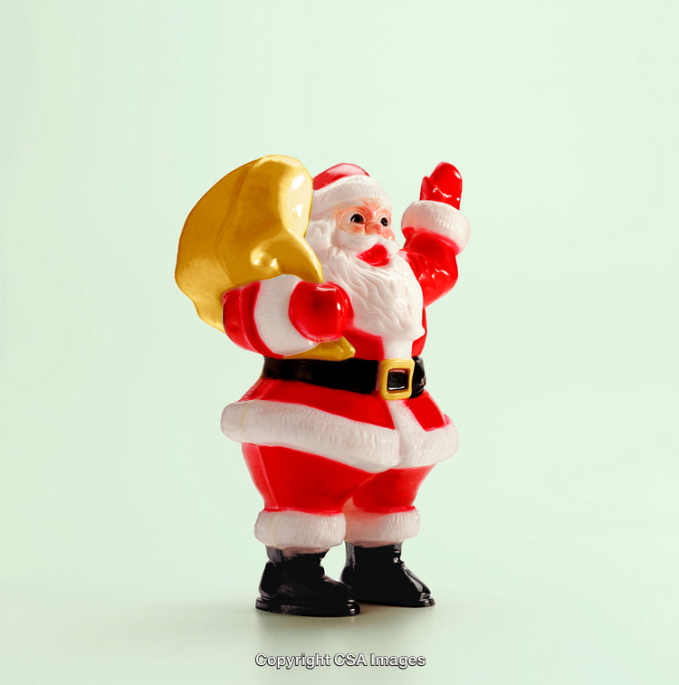 Santa Figurine Holding Gift Bag Waving on Light Background