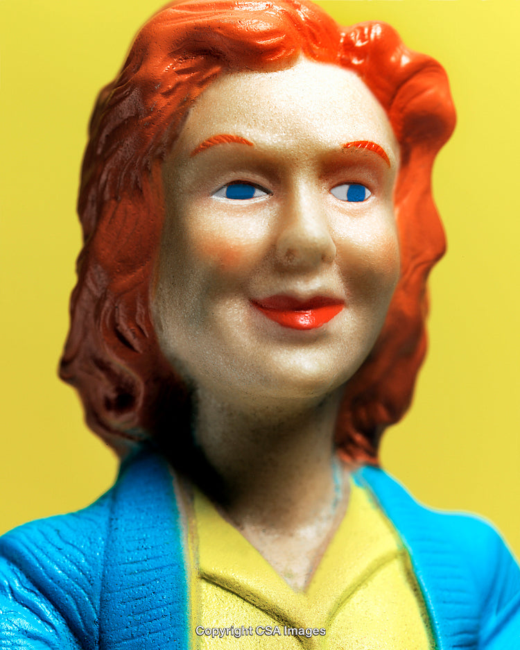 Close-Up of Vintage Plastic Figurine with Bright Colors on Yellow Background