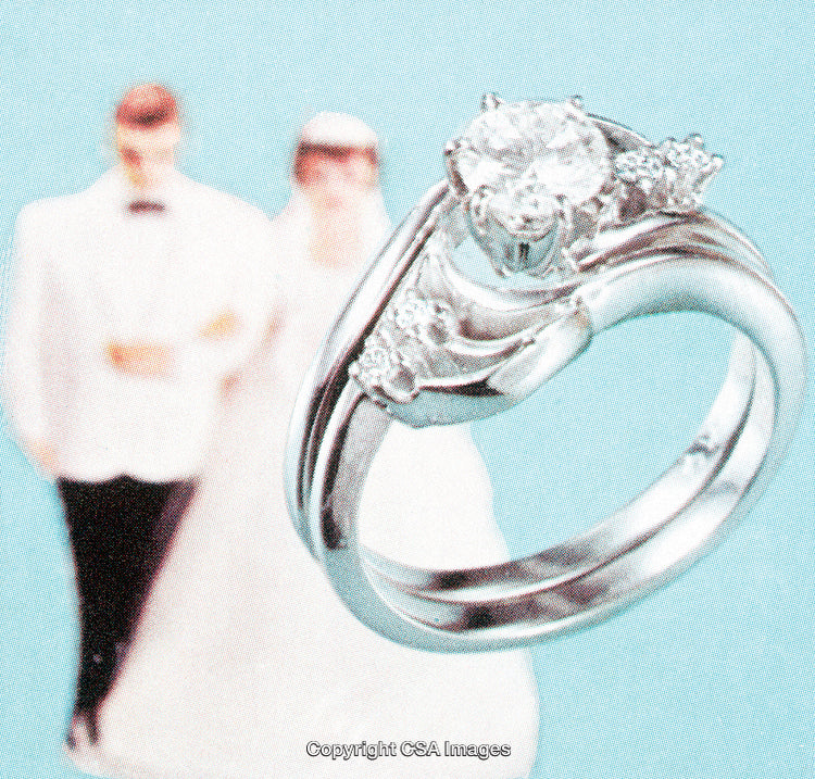 Elegant Wedding Rings Featuring a Diamond Stone and a Wedding Couple in Background
