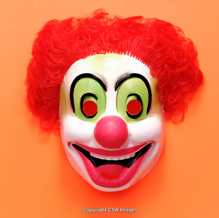 Colorful Clown Mask with Red Hair on an Orange Background