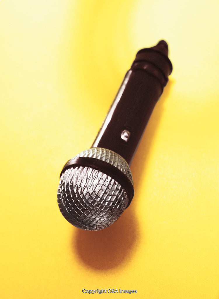 Close-Up of Microphone Toy Against a Yellow Background Surface