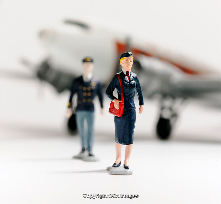 Miniature Models of Pilot and Flight Attendant Near Airplane