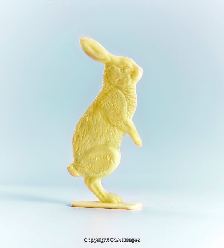 Yellow Plastic Rabbit Figurine on Light Blue Background