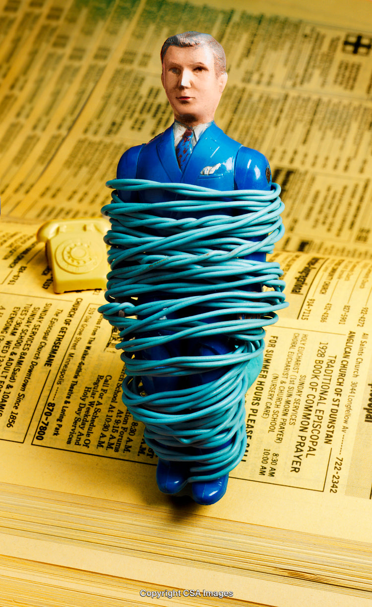 Toy Figure Tied with Blue Cord on Yellow Pages Background