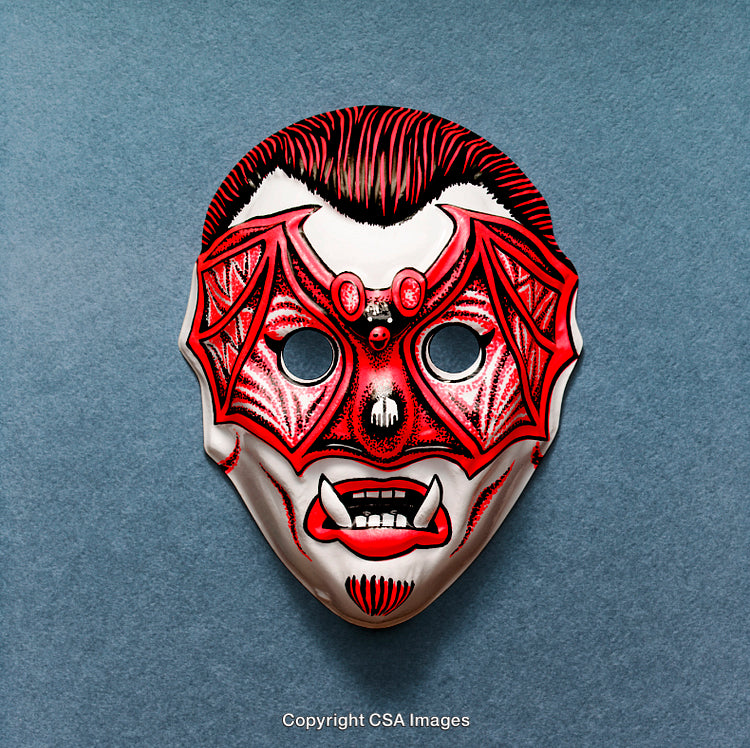 Colorful Decorative Mask with Vampire and Bat Motif on Blue Surface
