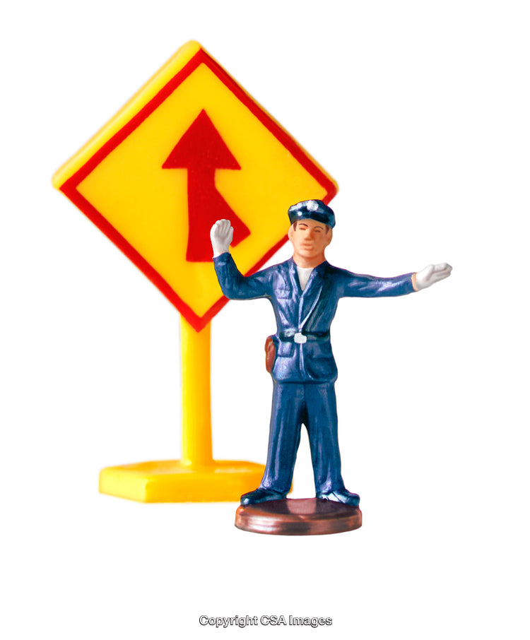 Plastic Toy Policeman with Traffic Sign on White Background
