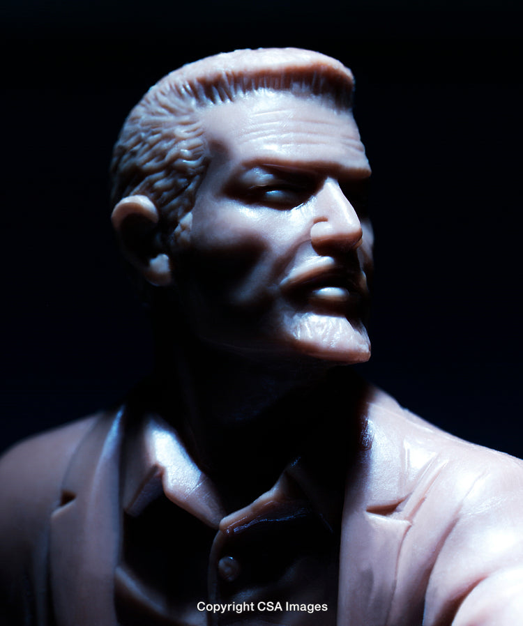 Detailed Close-Up of a Male Plastic Toy Figure in Dramatic Lighting