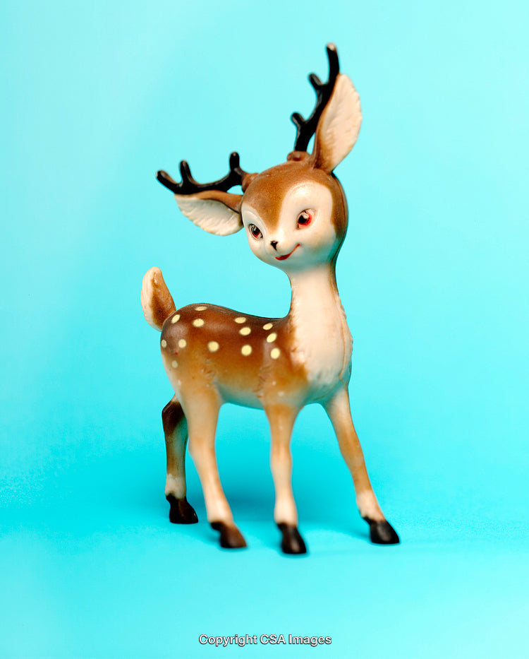 Cute Plastic Deer Figurine on Vibrant Blue Background