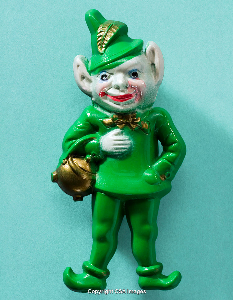 Green Plastic Figurine Depicting Whimsical Character With a Gold Pot in Hand
