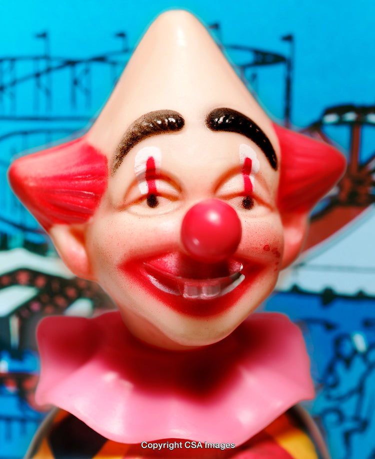 Colorful Plastic Clown Toy with Painted Features in Amusement Park Setting