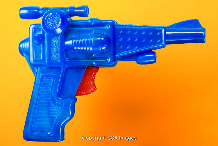 Blue Toy Ray Gun Against Vibrant Orange Background in Close-Up View