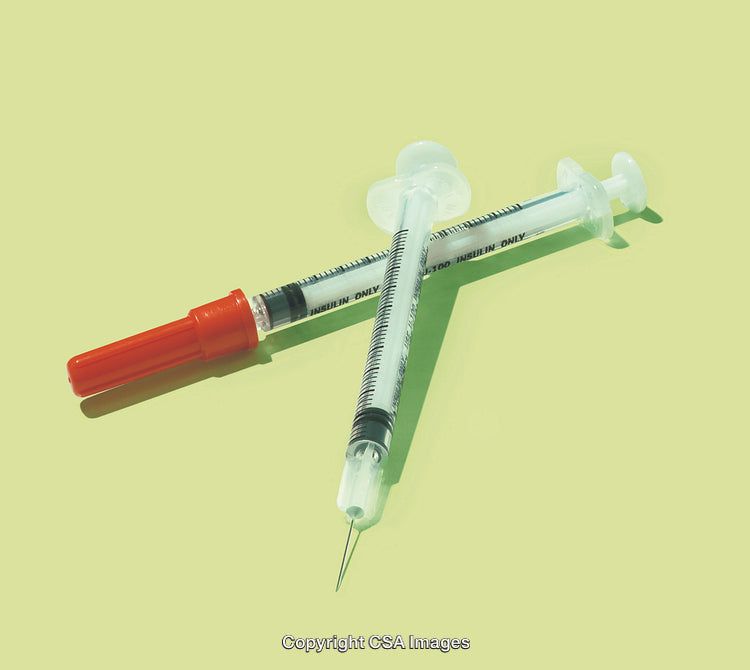 Sterile Insulin Syringes Crossed with Bright Green Background