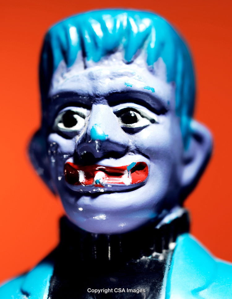 Close-Up of a Colorful Vintage Plastic Toy With Bright Orange Background