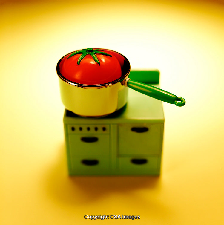 Colorful Toy Cookware Setup Featuring Tomato Pot on a Yellow Sheen
