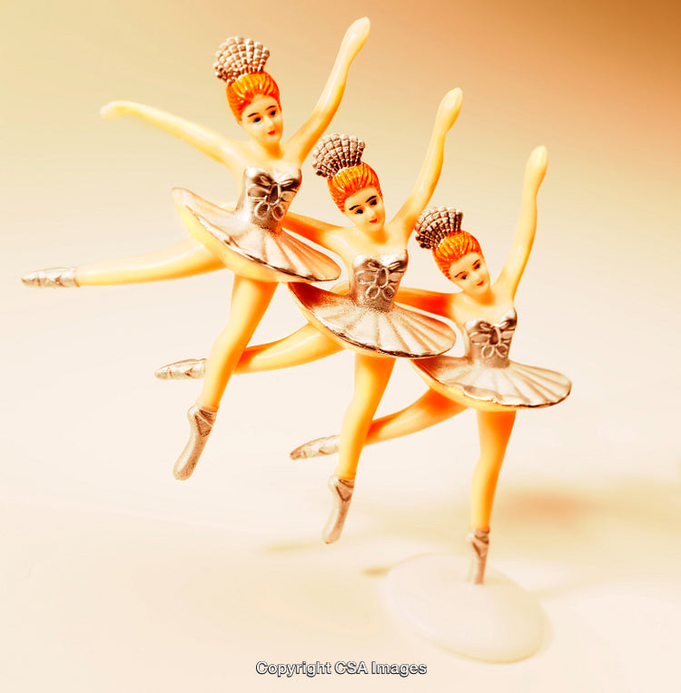 Graceful Toy Ballet Dancers in Elegant Poses Under Soft Lighting