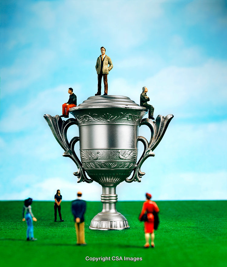 Miniature Plastic Figures Displayed on a Trophy on a Field