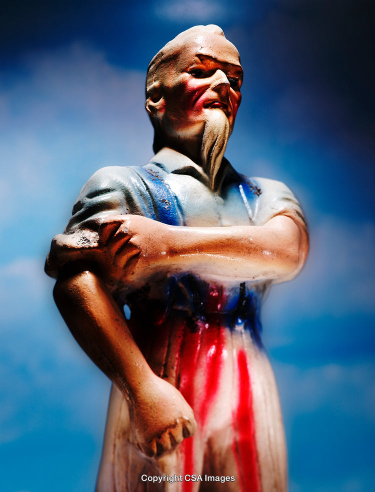 Close-Up of a Painted Figurine Against a Vivid Blue Sky