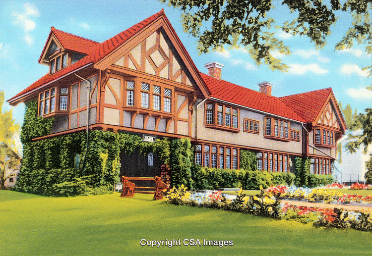Large Tudor-Style Home with Ivy-Covered Walls and Lush Garden Surroundings