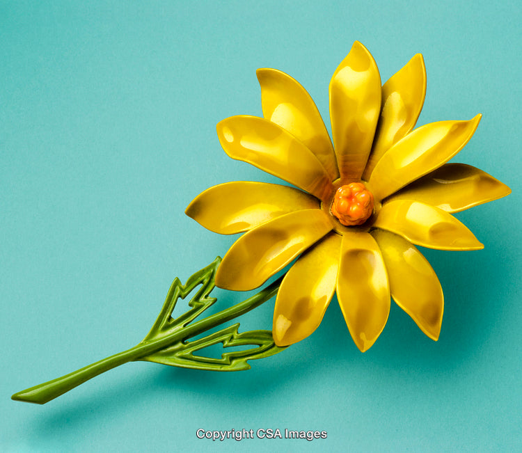 Yellow Daisylike Plastic Flower on Bright Blue Background