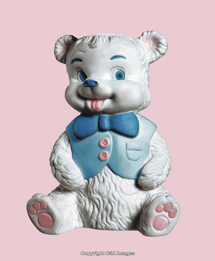 White Bear Figurine With Blue Vest and Bow on Pink Background