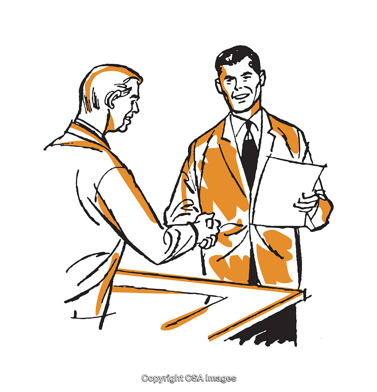 Two Business Professionals Shaking Hands While Reviewing Important Documents