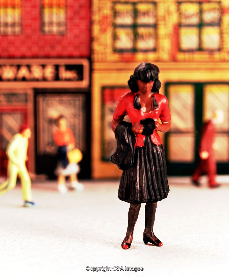 Miniature Figure of a Woman Walking on a City Street