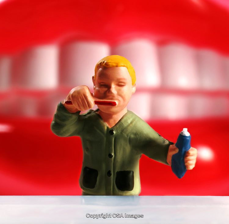Toy Figurine Brushing Teeth with Toothpaste and Toothbrush in Bathroom Setting