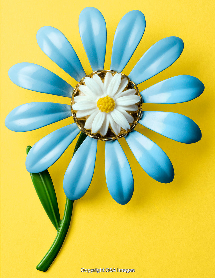 Colorful Plastic Floral Toy With Blue Petals and Yellow Background