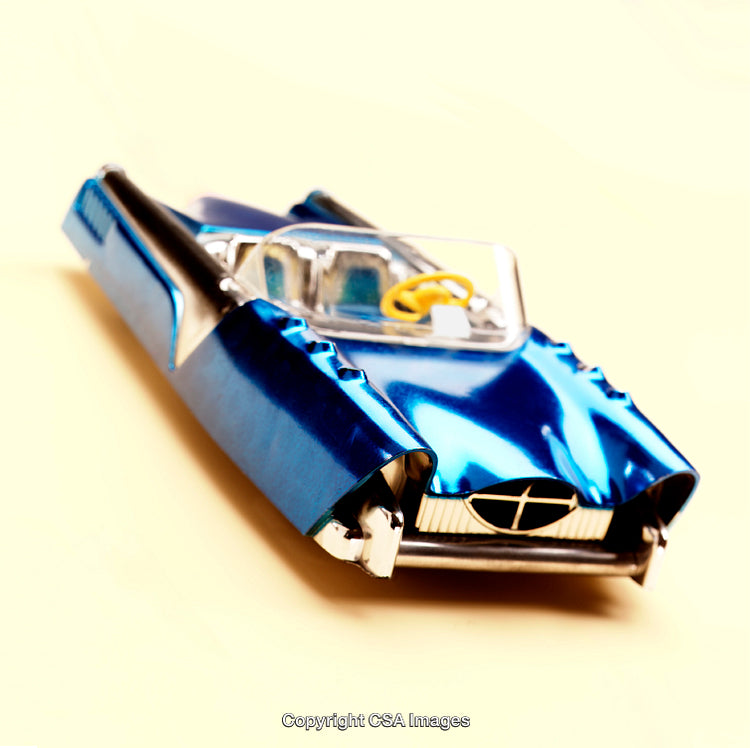 Retro Blue Plastic Toy Vehicle with Futuristic Design on Light Background