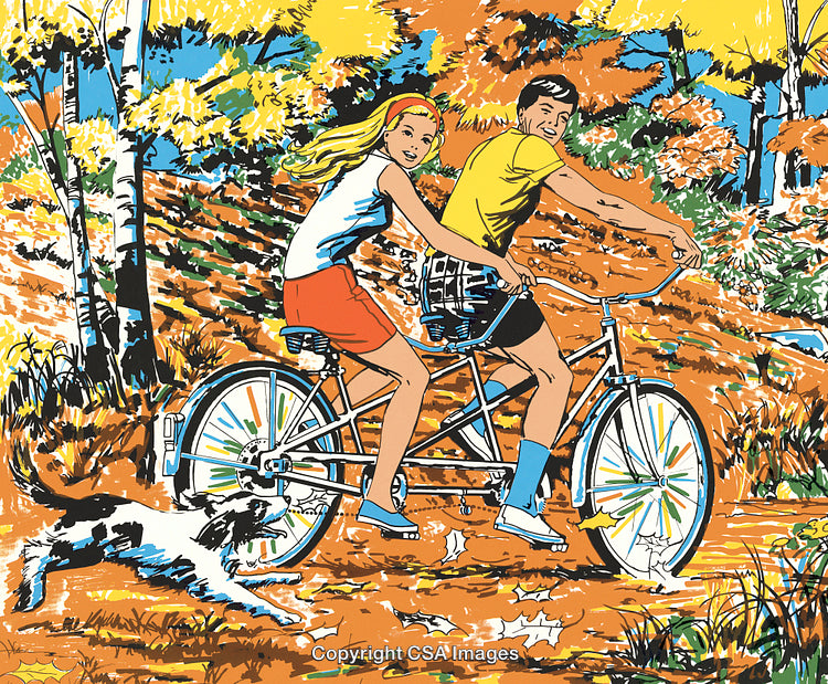 Couple Riding Tandem Bicycle Through Autumn Forest With Their Dog Companion