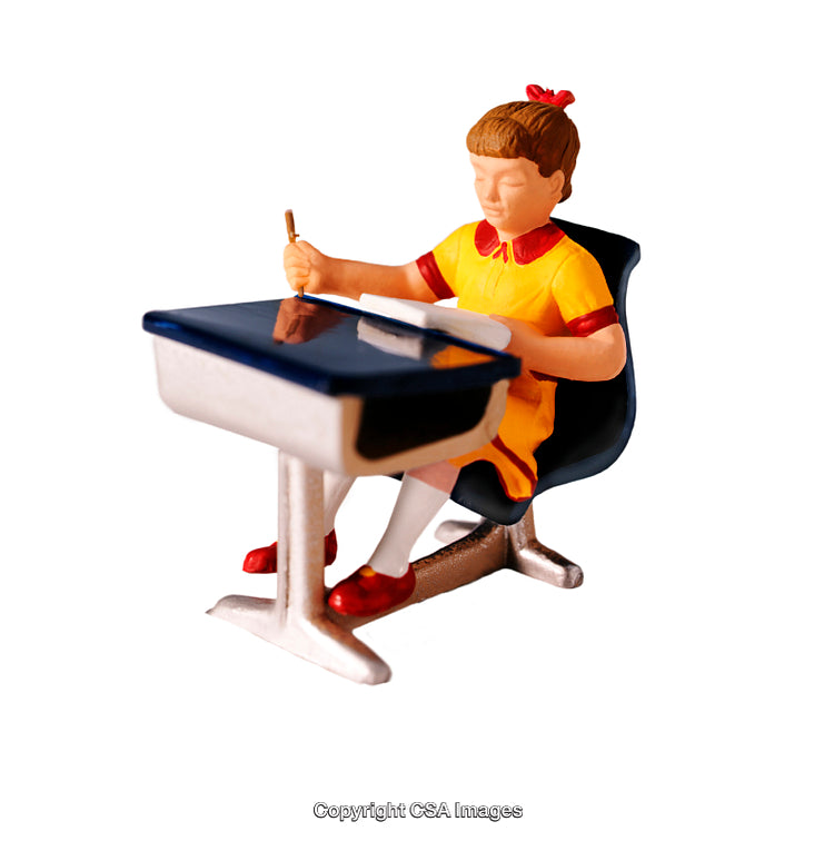 Painted Figurine of a Girl at a Desk on White Background