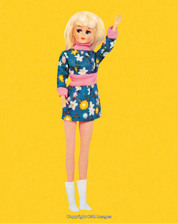 Vintage Doll in Floral Dress on Bright Yellow Background with Nostalgic Vibes