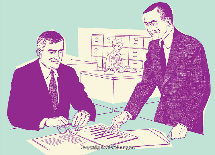 Two Colleagues Reviewing Data in Office With Secretary in Background