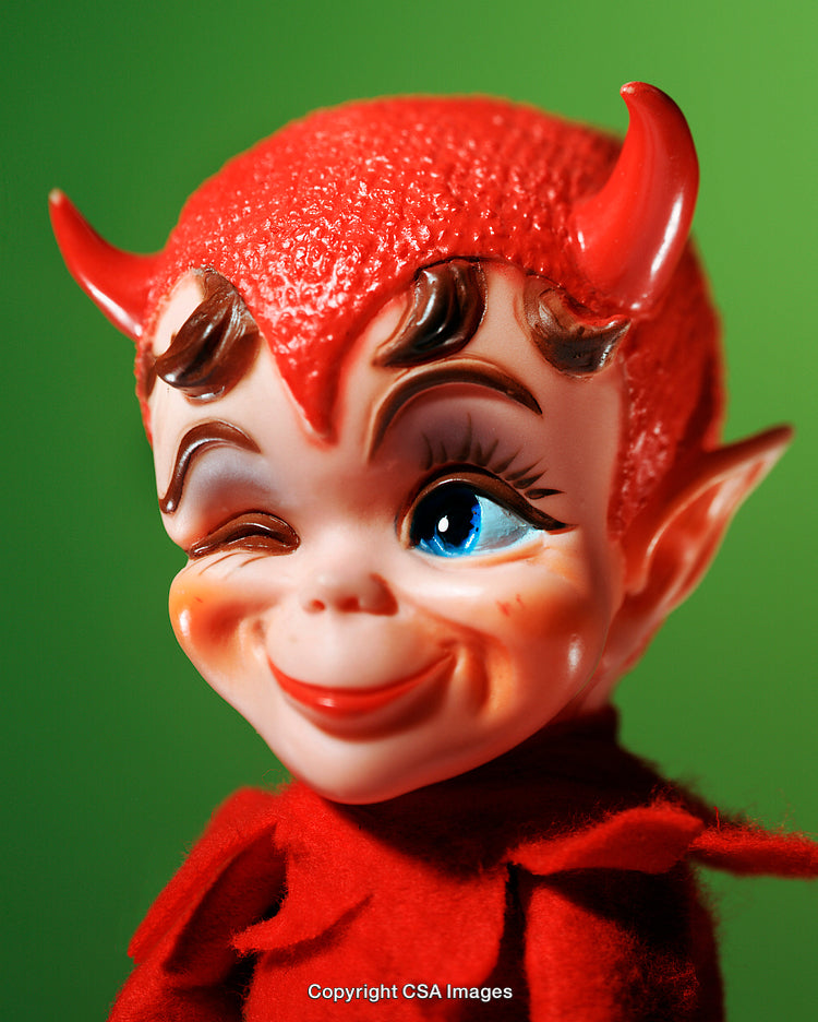 Cheerful Plastic Toy Figure with Red Devil Costume on Green Background