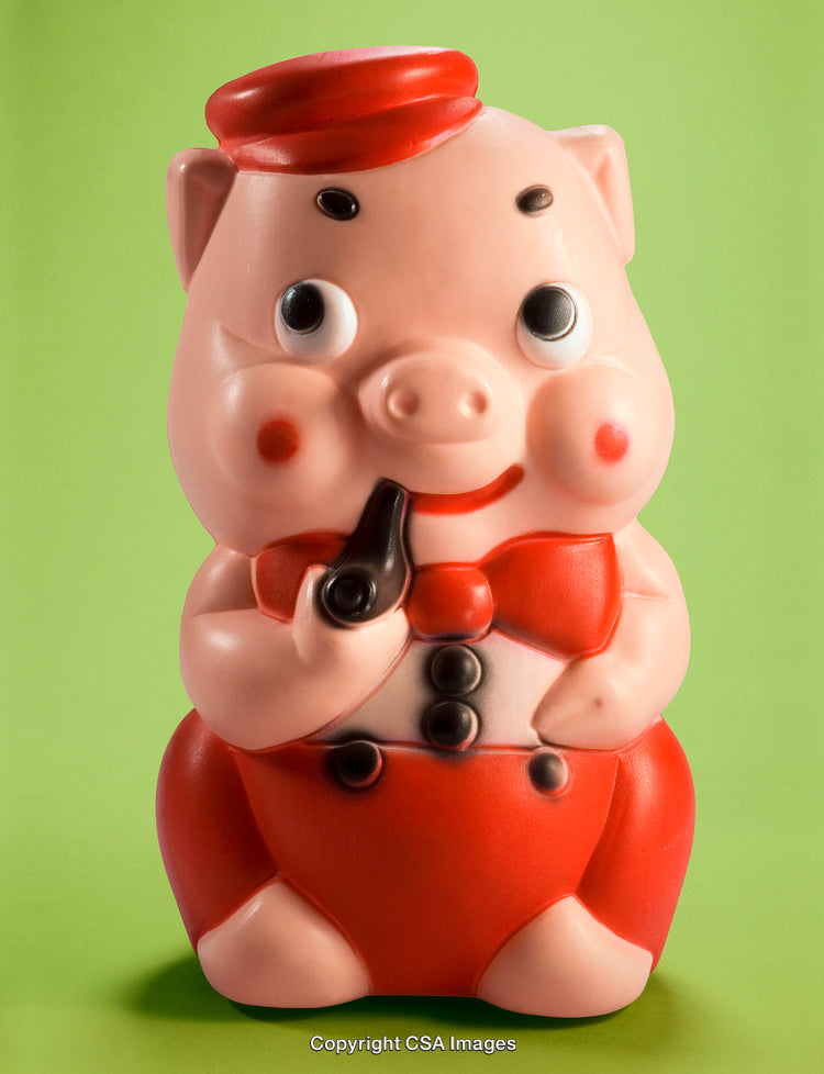 Cute Plastic Piggy Figurine with Red Outfit on Green Background