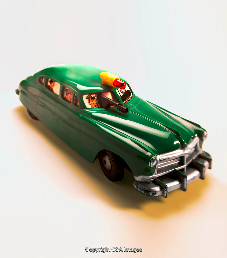 Vintage Green Toy Car with Characters Visible Inside and Classic Design