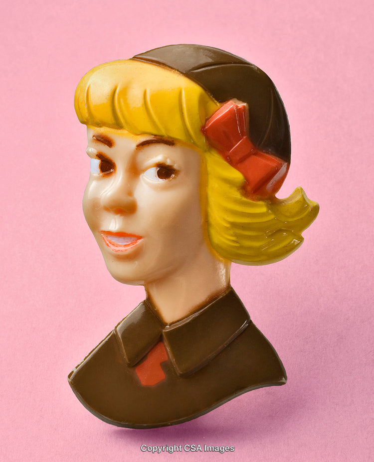 Close-Up of a Blonde Figurine on Pink Background