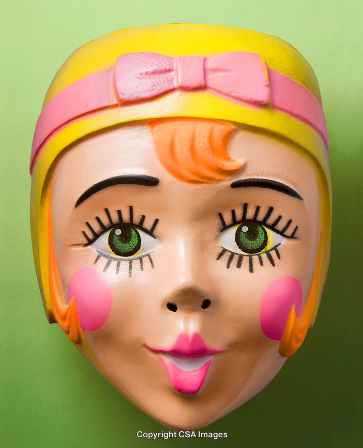 Colorful Vintage Plastic Toy Mask on Green Background
