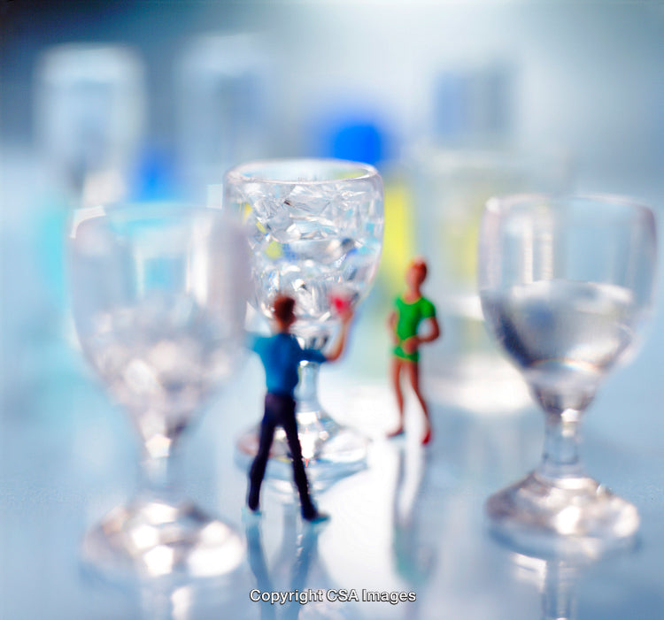 Tiny Figures Interacting Among Glasses on a Soft Blurred Background