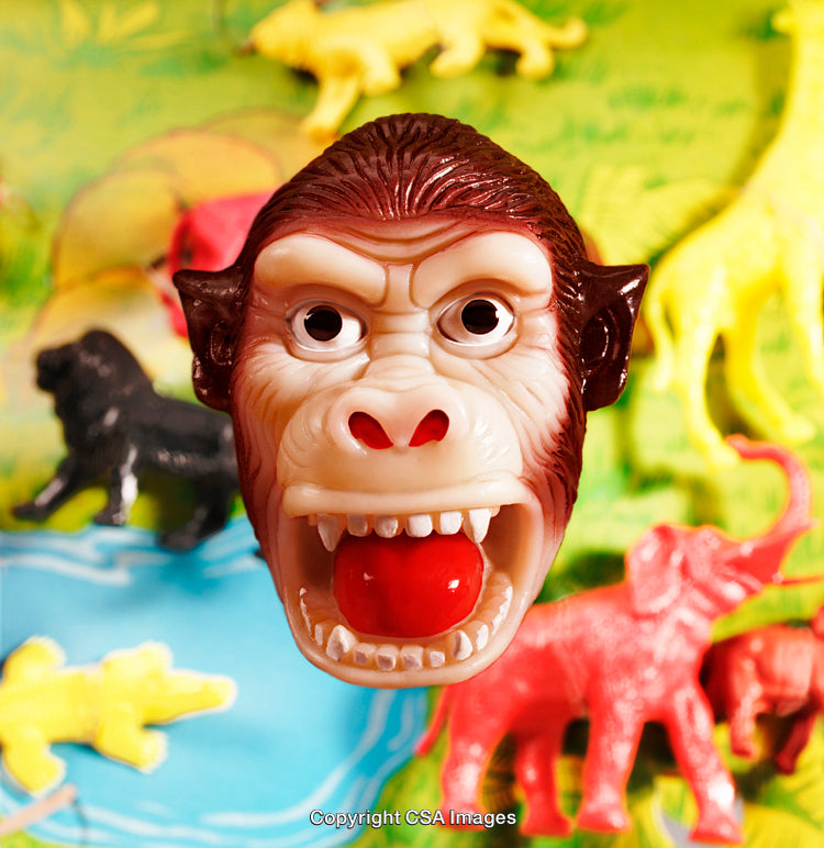 Close-Up of a Plastic Gorilla Face Among Colorful Toy Animals