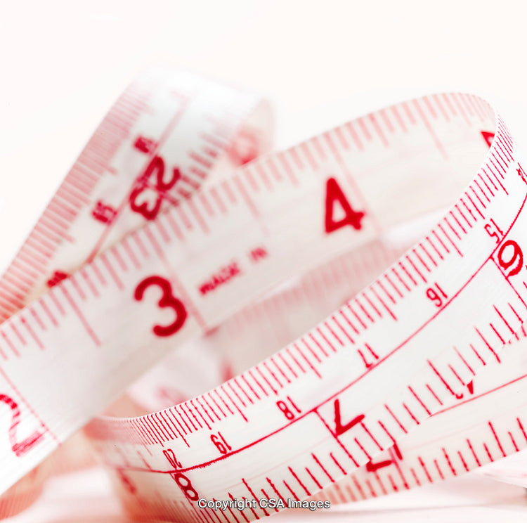 Close-Up of Measuring Tape Showing Red and White Measurements