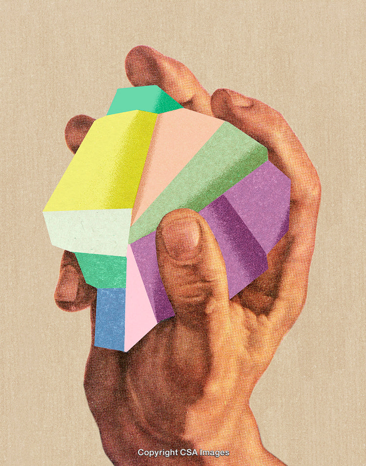 Hand Holding Multicolored Polygon Object on Beige Textured Background