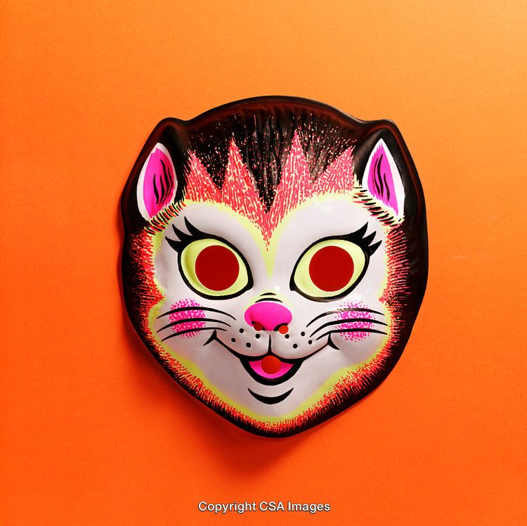 Bright Plastic Cat Mask Against Vibrant Orange Background